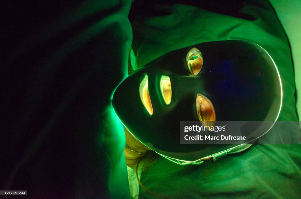 Headshot of woman with light therapy facial mask