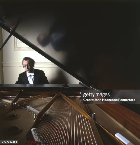 Czechoslovak born Austrian pianist and composer Alfred Brendel posed seated at his Steinway & Sons grand piano in 1984.