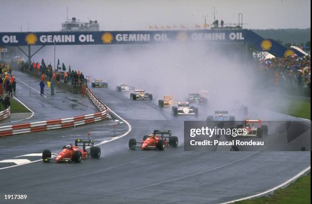 General view of the field driving through the spray at the start of the British Grand Prix at the Silverstone circuit in England. \ Mandatory Credit:...