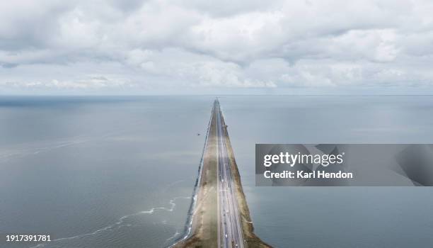 a daytime view of a bridge in the netherlands - afsluitdijk stockfoto's en -beelden
