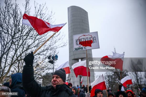 People supporting right-wing opposition Law and Justice party attend 'Free Poles Protest' in front of parliament building in Warsaw, Poland on...