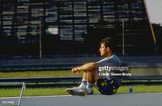 Dallara Cosworth driver Alex Caffi of Italy relaxes in the sun before the Brazilian Grand Prix at the Rio circuit in Brazil. Caffi did not qualify. \...