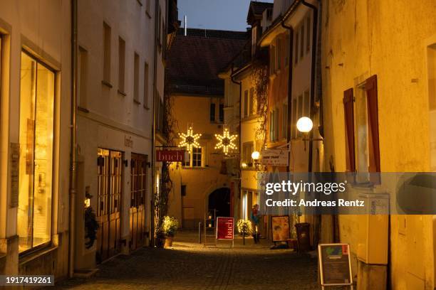 Visitors stroll along a shopping mile beside the annual Lindau Christmas market on January 3, 2024 in Lindau, Germany. Visitors will encounter small...