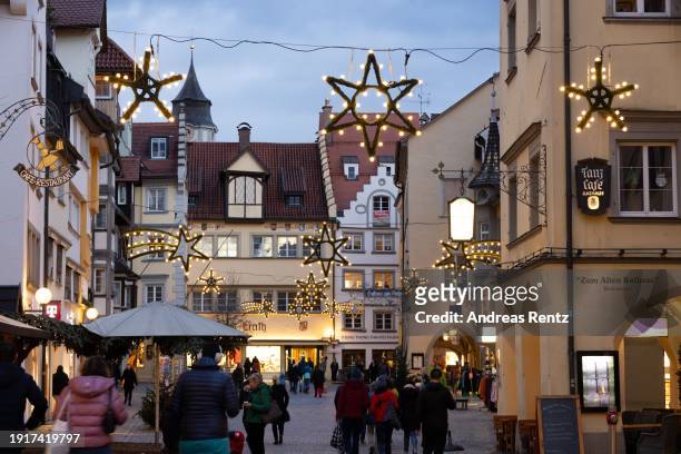 Visitors stroll along a shopping mile beside the annual Lindau Christmas market on January 3, 2024 in Lindau, Germany. Visitors will encounter small...