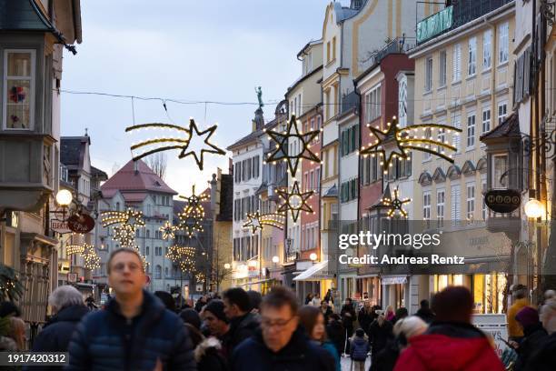 Visitors stroll along a shopping mile beside the annual Lindau Christmas market on January 3, 2024 in Lindau, Germany. Visitors will encounter small...