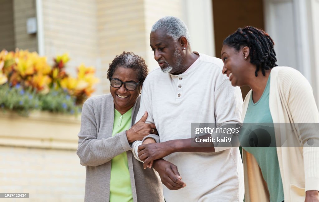 Senior African-American couple walking with daughter