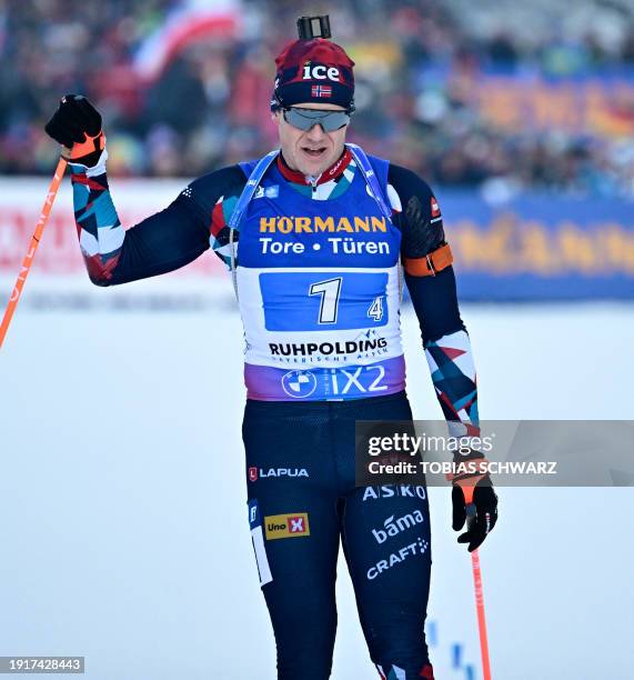 Norway's Vetle Sjastad Christiansen reacts as he crosses the finish line of the men's 4x7,5km relay event of the IBU Biathlon World Cup in...