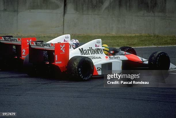Alain Prost of France and Ayrton Senna of Brazil collide in their McLaren Hondas during the Japanese Grand Prix at the Suzuka circuit in Japan. Prost...