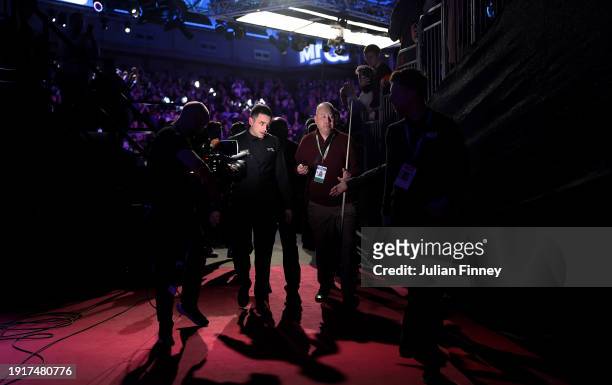 Ronnie O'Sullivan of England leaves the arena after his first round match against Ding Junhui of People's Republic of China during day two of the MrQ...