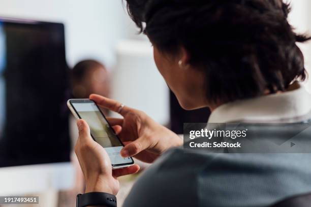 checking our social engagement - over the shoulder view stock pictures, royalty-free photos & images