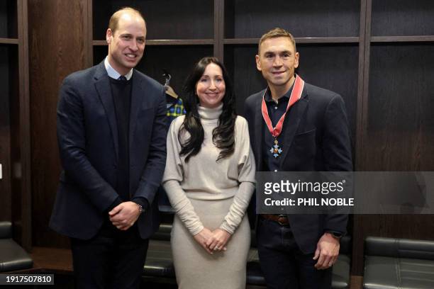 Britain's Prince William, Prince of Wales poses with Kevin Sinfield and his wife, Jayne , after presenting him with a CBE medal at Headlingley...