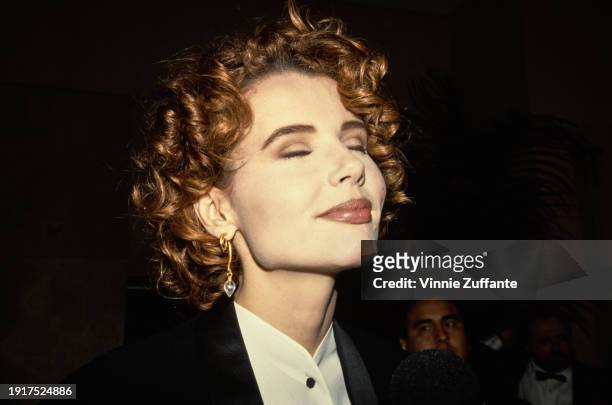 Headshot of American actress Geena Davis, wearing a black jacket over a collarless white shirt with black buttons, attends the 44th Annual Directors...