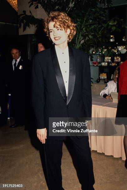 American actress Geena Davis, wearing a black tuxedo over a white shirt with black buttons, attends the 44th Annual Directors Guild Awards, held at...