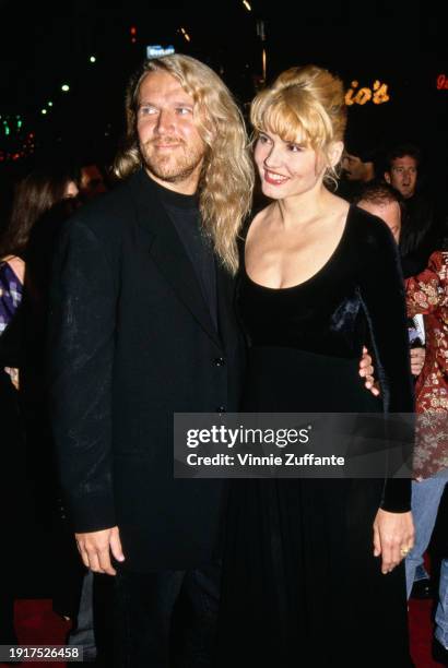 Finnish film director Renny Harlin, wearing a black suit over a black crew neck top, and his wife American actress Geena Davis, who wears a...