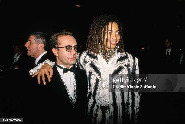 British lyricist Bernie Taupin, wearing a tuxedo and bow tie, and American singer and songwriter Terence Trent D'Arby, who wears a black-and-white...