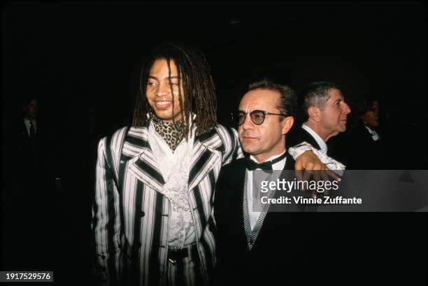 American singer and songwriter Terence Trent D'Arby, wearing a black-and-white blazer over a white lace shirt and a leopard-print cravat, and British...