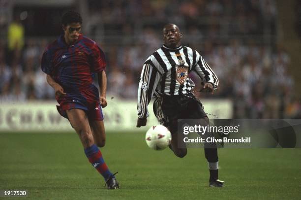 Michael Reiziger of Barcelona takes on Faustino Asprilla of Newcastle United during the Champions League match at St James'' Park in...
