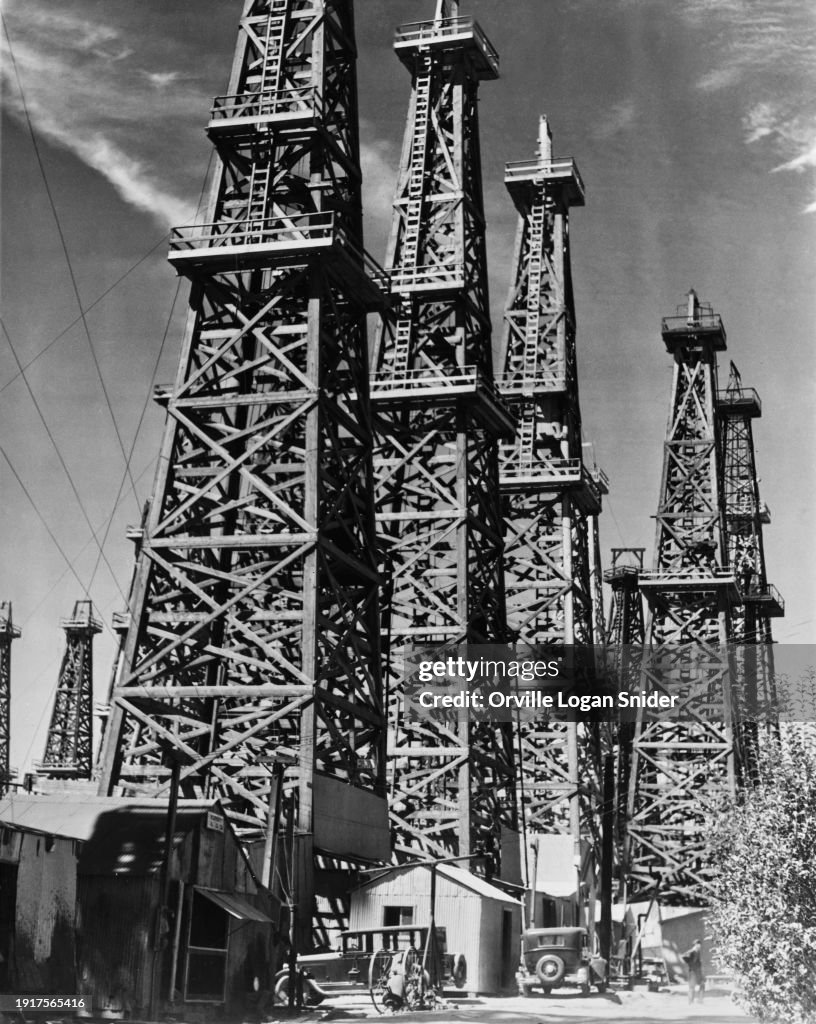 Oil Derricks A low-angle view of derricks and drilling rigs on the oil wells that ...