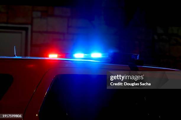 police officers suv vehicle with overhead flashing siren lights - police car driving stock pictures, royalty-free photos & images