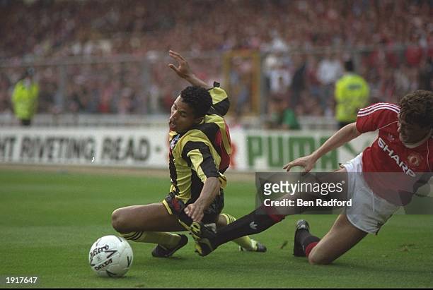 John Salako of Crystal Palace is fouled by Steve Bruce of Manchester United during the FA Cup final replay at Wembley Stadium in London. Manchester...