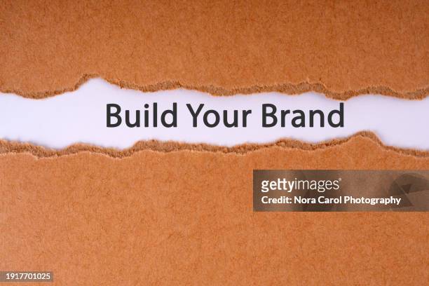 build your brand text on torn paper - branding identity stock pictures, royalty-free photos & images