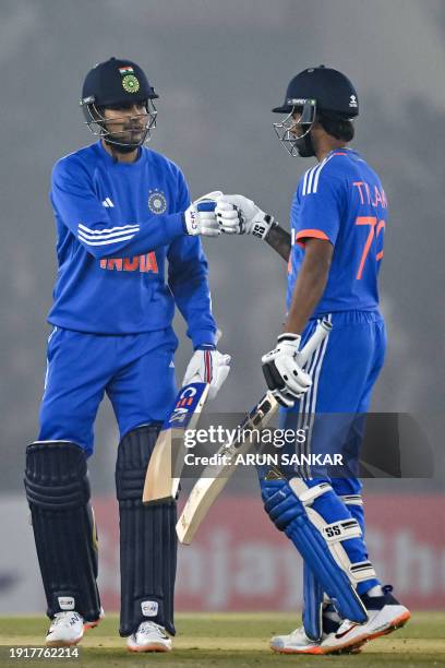 India's Shubman Gill and Tilak Varma bump their fists during the first Twenty20 international cricket match between India and Afghanistan at the...