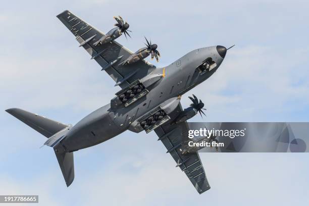 airbus a-400m military transporter with landing gear in the sky - transporter stock pictures, royalty-free photos & images