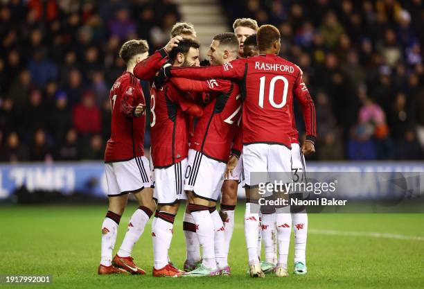 Bruno Fernandes of Manchester United is congratulated by teammates after scoring their team's second goal from the penalty spot during the Emirates...