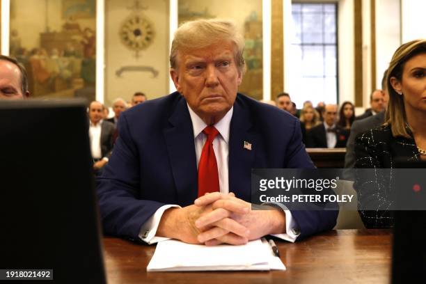 Former US President Donald Trump sits in New York State Supreme Court during the civil fraud trial against the Trump Organization, in New York City...