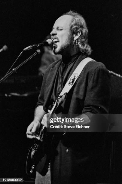 American Rock musician Paul Barrere , of band Little Feat, plays guitar as he performs on stage at the Beacon Theatre, New York, New York, October...