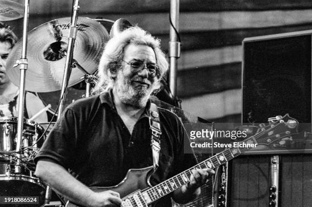 American Rock musician Jerry Garcia plays guitar as he performs on stage, with the band Grateful Dead, at Cal Expo Amphitheatre, Sacramento,...
