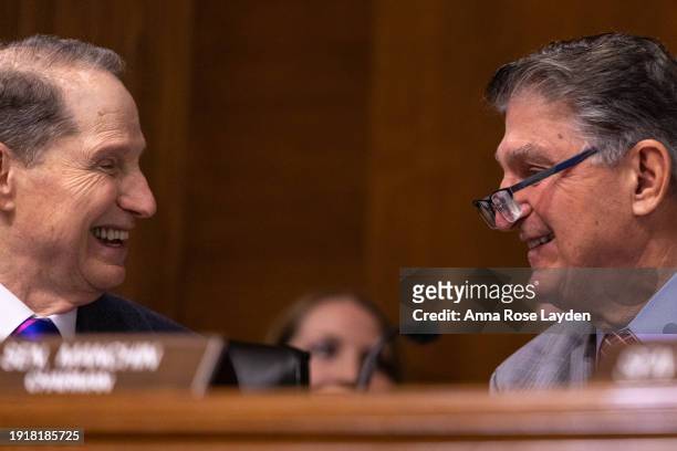 Chairman Joe Manchin and Sen. Ron Wyden smile during a Senate Energy and Natural Resources Committee hearing on Federal Electric Vehicle Incentives...