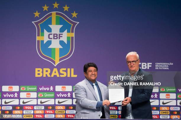 Dorival Junior poses with the president of the Brazilian Football Confederation Ednaldo Rodrigues and the new contract during his presentation as the...