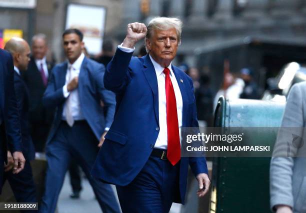 Former US President Donald Trump departs after speaking to the press after attending the civil fraud trial against the Trump Organization in New York...