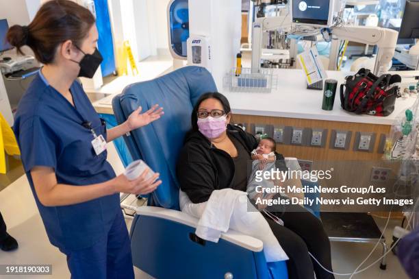 Los Angeles, CA Dr Roxanne Arcinue talks with Johanna Farias as she holds her son Ricky at Providence Cedars-Sinai Tarzana Medical Center's Neonatal...