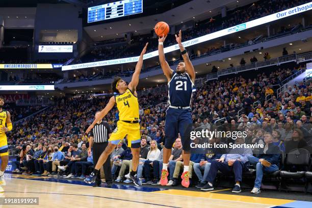 Butler Bulldogs guard Pierre Brooks II shoots a three pointer over Marquette Golden Eagles guard Stevie Mitchell during the men's college basketball...