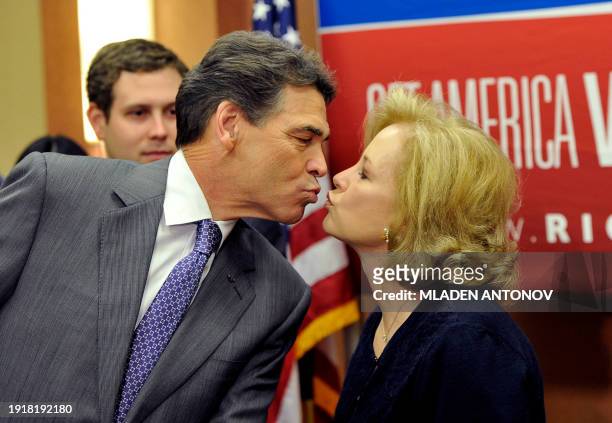 Texas Governor Rick Perry kisses his wife Anita as he announced that he is suspending his campaign as a Republican presidential candidate, January 19...