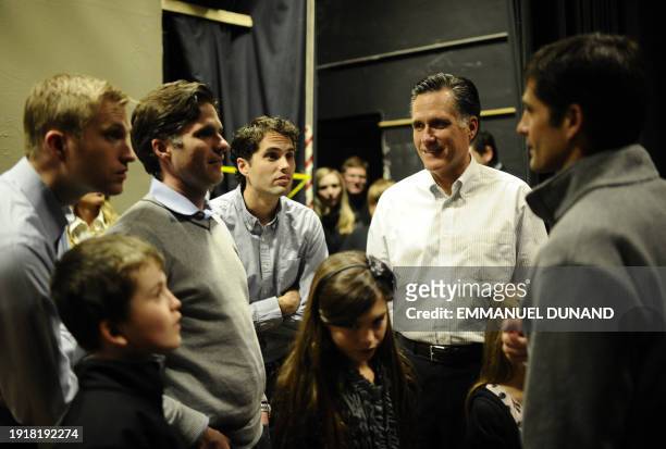 Republican presidential hopeful Mitt Romney share a moment with his children and grand-children prior to get on stage to address a rally at McKelvie...