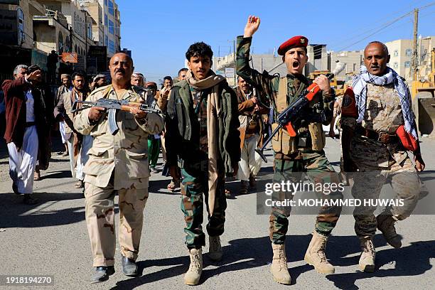 Huthi fighters brandish their weapons during a march in solidarity with the Palestinian people in the Huthi-controlled capital Sanaa on January 11...