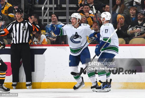 Brock Boeser of the Vancouver Canucks celebrates his goal with Filip Hronek during the first period against the Pittsburgh Penguins at PPG PAINTS...