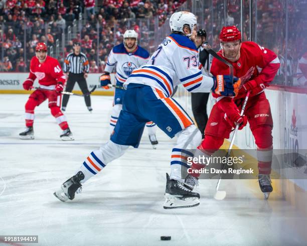 Christian Fischer of the Detroit Red Wings tries to skate by the defense of Vincent Desharnais of the Edmonton Oilers during the first period at...