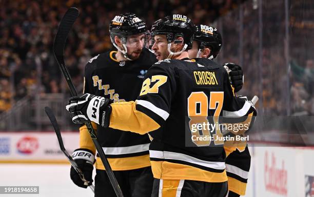 Sidney Crosby of the Pittsburgh Penguins celebrates with teammates after scoring a goal in the second period against the Vancouver Canucks at PPG...