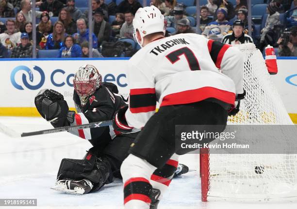 Ukko-Pekka Luukkonen of the Buffalo Sabres and Brady Tkachuk of the Ottawa Senators look to the net after a goal by Claude Giroux during the third...