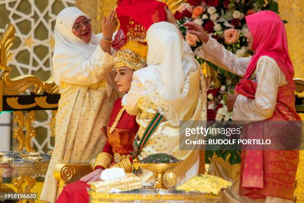 This picture taken on January 10, 2024 shows Brunei's Prince Abdul Mateen's bride Yang Mulia Anisha Rosnah during the royal powdering ceremony at...