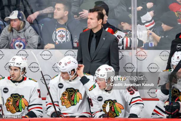 Head Coach Luke Richardson of the Chicago Blackhawks looks on from the bench during third period action against the Winnipeg Jets at the Canada Life...