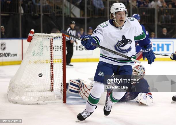 Brock Boeser of the Vancouver Canucks celebrates his goal as Igor Shesterkin of the New York Rangers reacts during the first period at Madison Square...