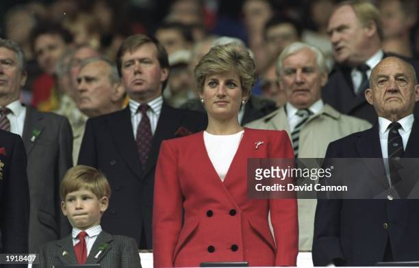 Princess Diana and HRH Prince Harry stand for the National Anthem at the Wales v Australia match during the 1991 World Cup at Cardiff Arms Park in...