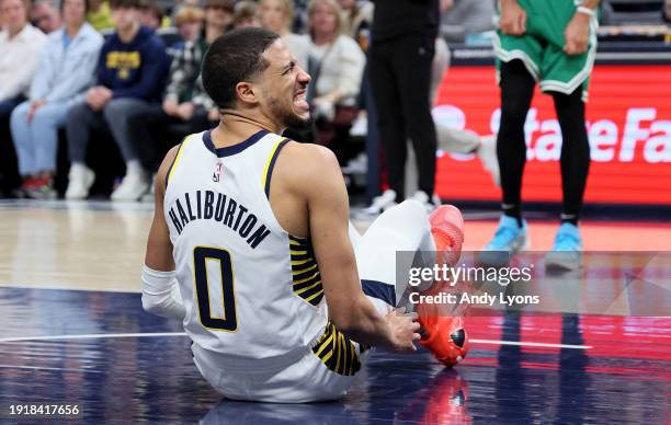 Tyrese Haliburton of the Indiana Pacers grimaces after injuring his leg in the first half against the Boston Celtics at Gainbridge Fieldhouse on...
