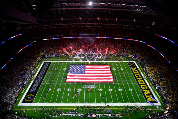View of the American flag during the national anthem prior to the 2024 CFP National Championship game between the Washington Huskies and Michigan...