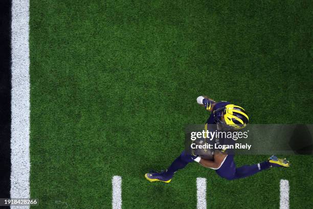 Donovan Edwards of the Michigan Wolverines runs the ball for a touchdown in the first quarter against the Washington Huskies during the 2024 CFP...